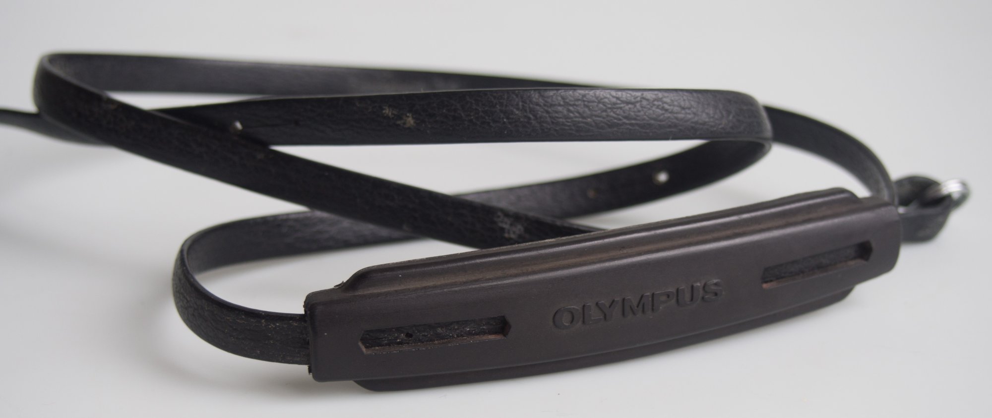 Used Olympus narrow SLR strap with gripping shoulder pad